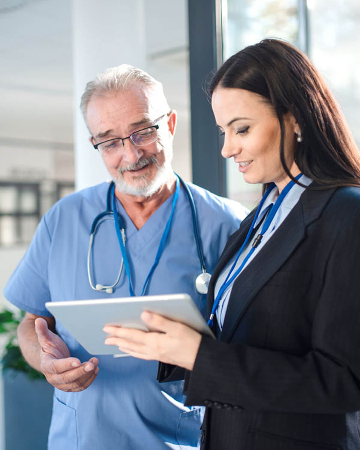 a consultant and a doctor looking at a tablet